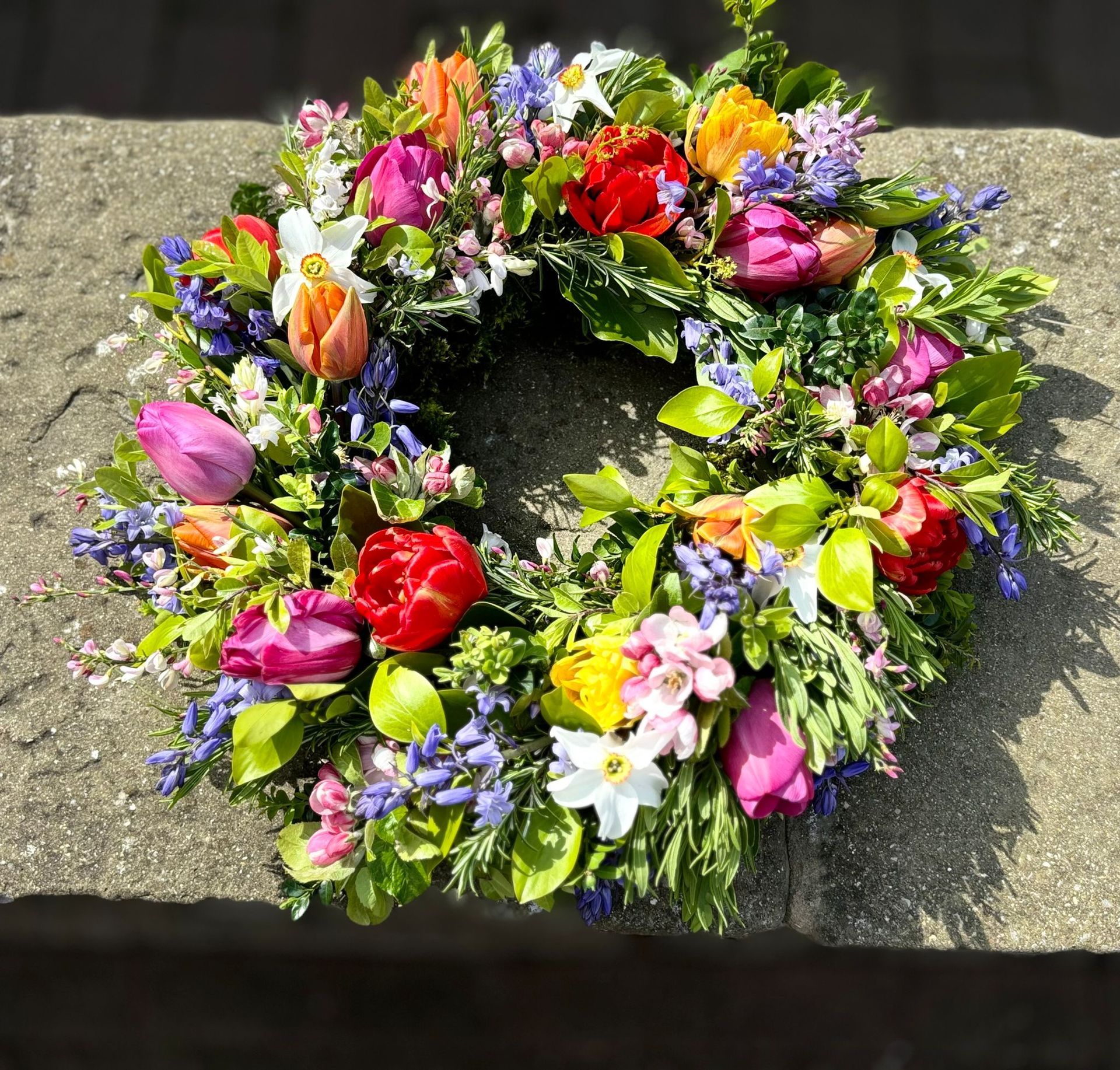 A wreath of flowers is sitting on a concrete surface