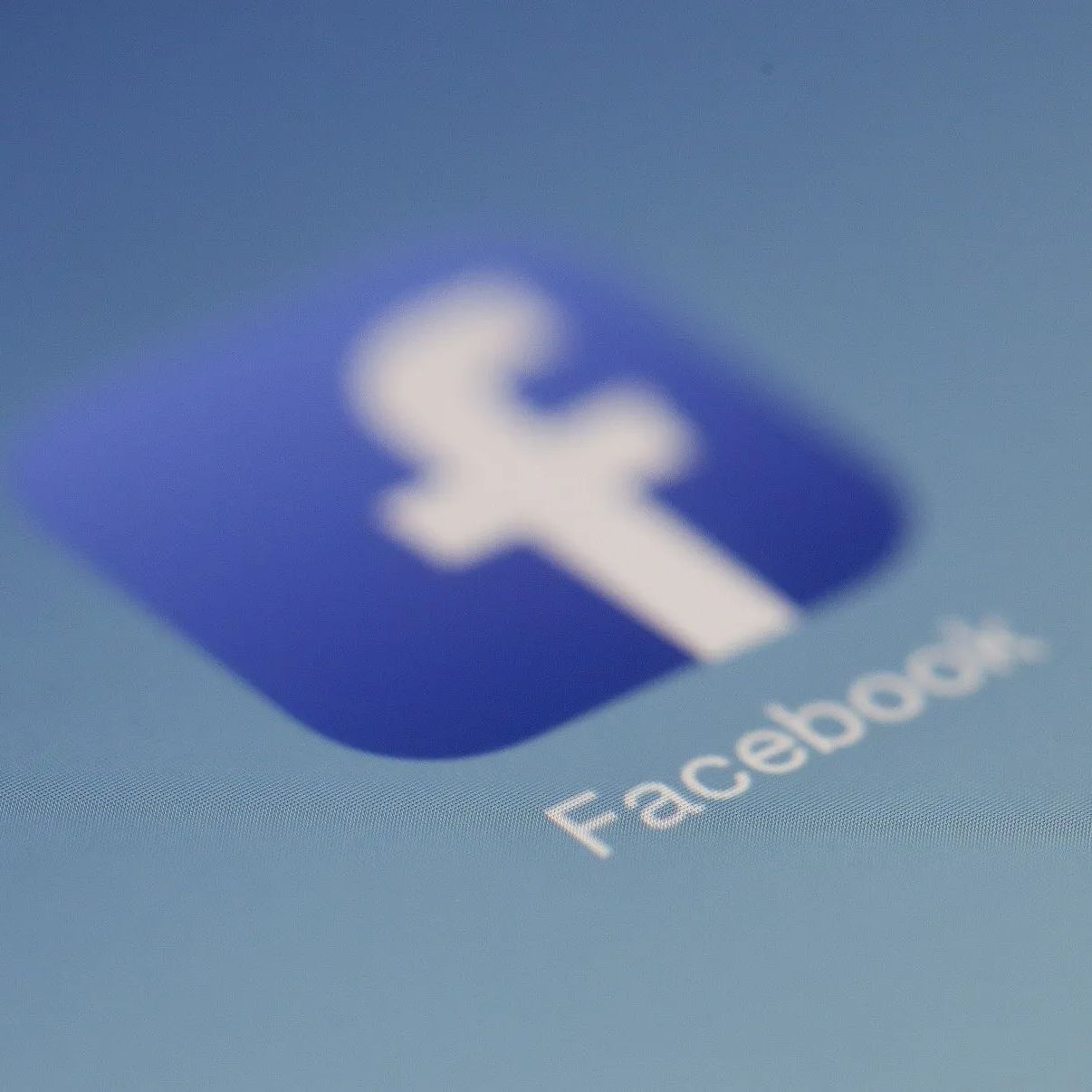 A close up of a facebook logo on a blue background
