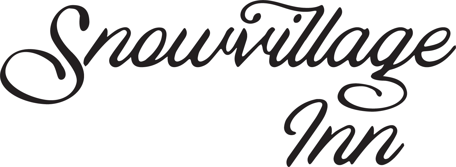 Snowvillage Inn logo in black script on a white background