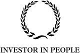 A black and white logo for an investor in people with a laurel wreath.