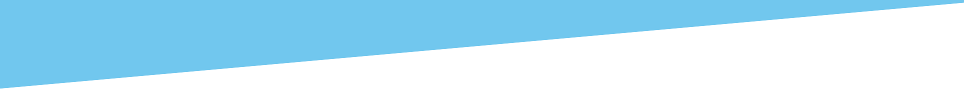 A piece of blue paper is being cut in half on a white background.