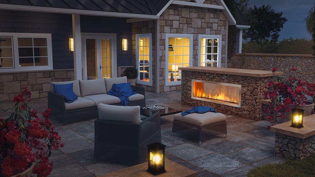 Backyard patio with outdoor fireplace and evening seating area