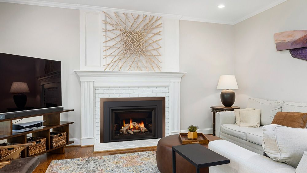 Gas fireplace with white mantel in a cozy living room