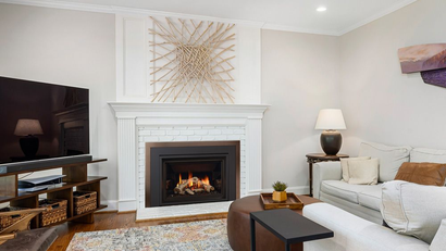 Regency gas fireplace insert installed in a traditional living room with white mantel