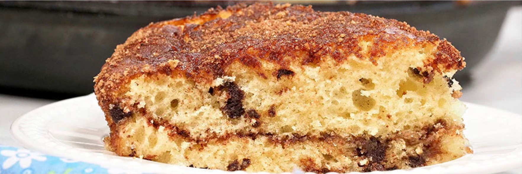 Chocolate chip cast-iron coffee cake with cinnamon filling and a golden brown topping