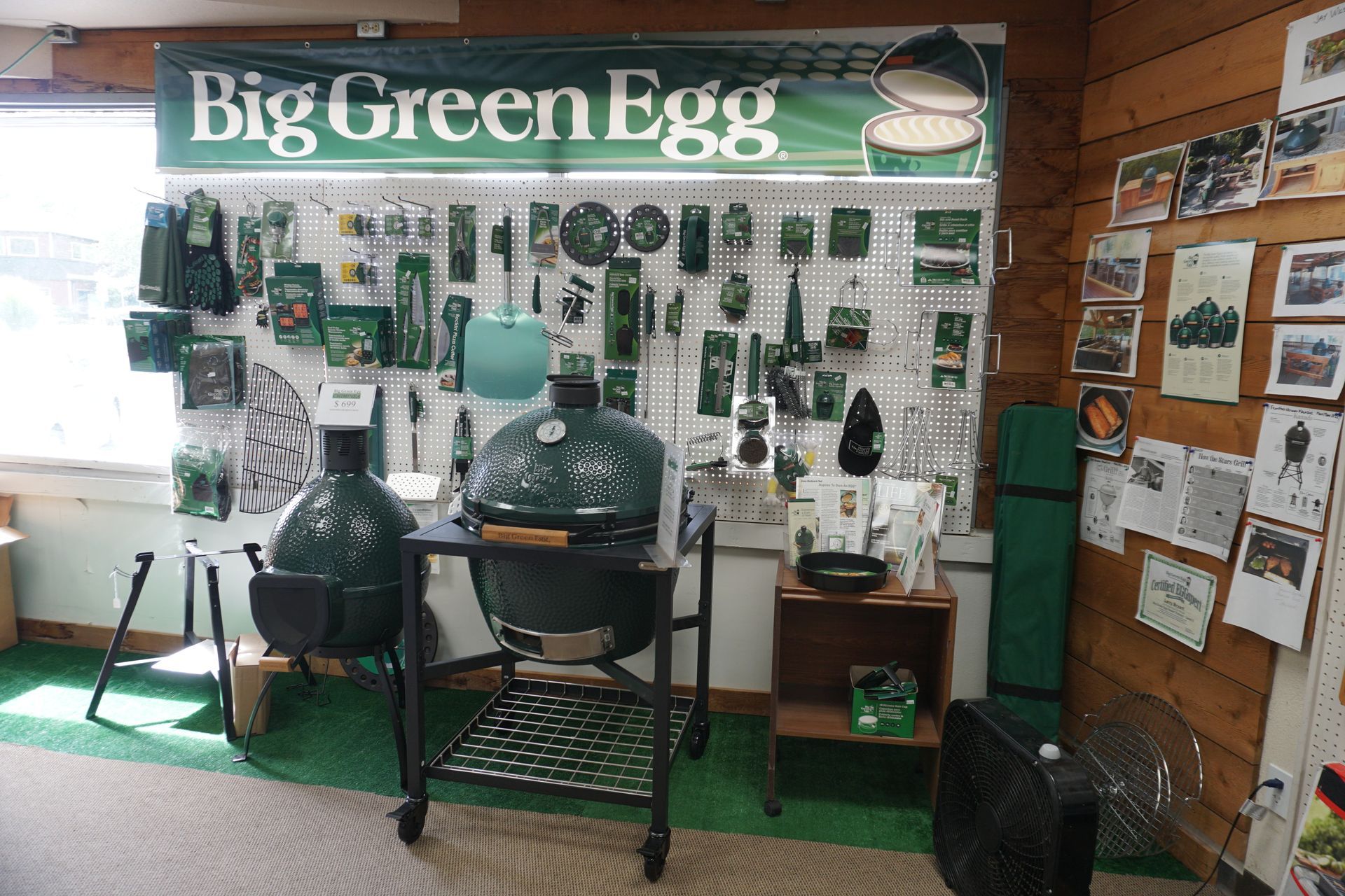 Big Green Egg ceramic smokers and accessories displayed inside our fireplace and grill showroom