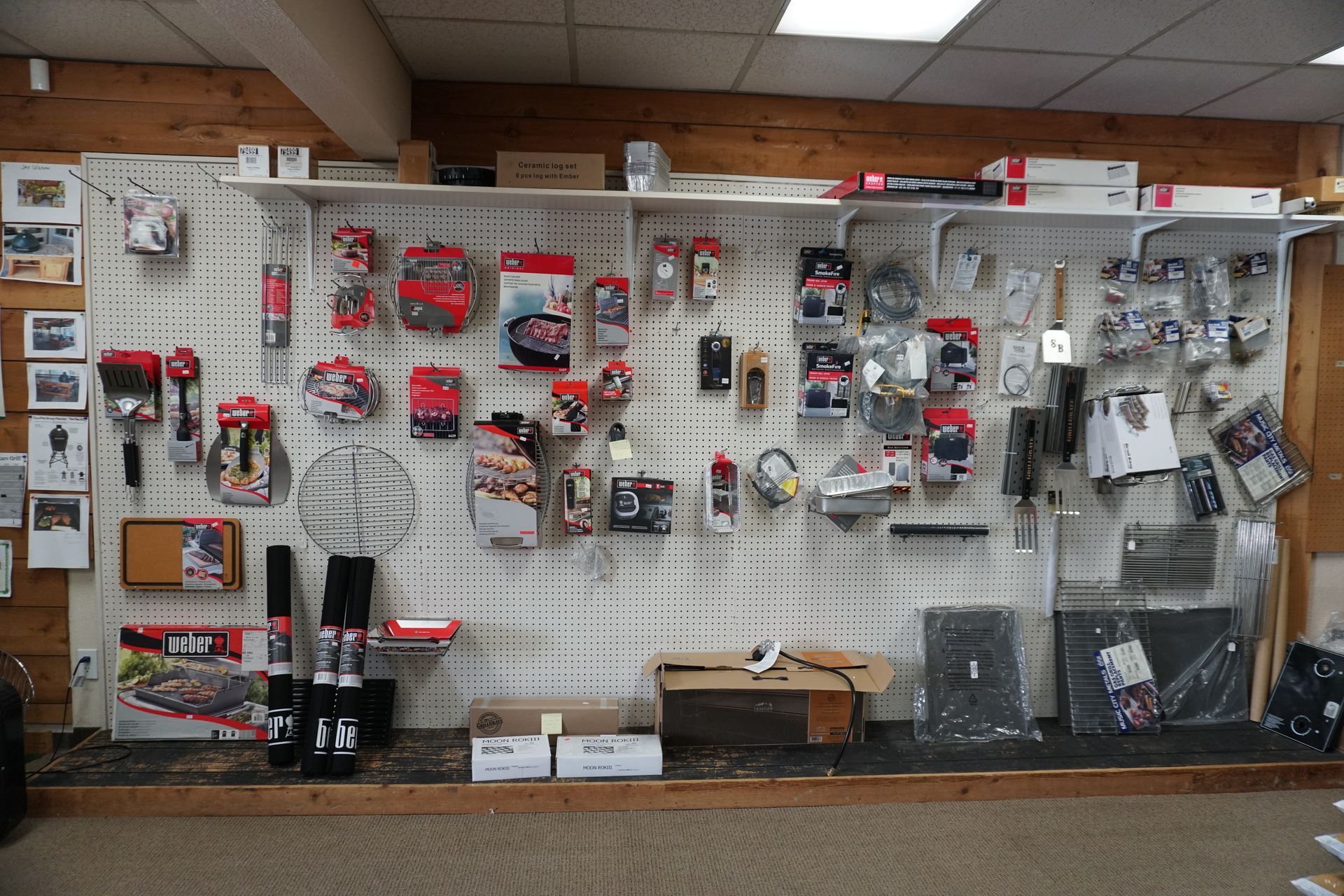 Wall display of BBQ grill accessories and outdoor cooking tools inside our grill showroom