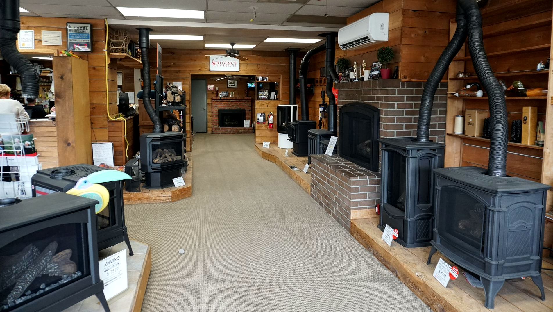 Indoor showroom featuring fireplace and stove displays in Olympia