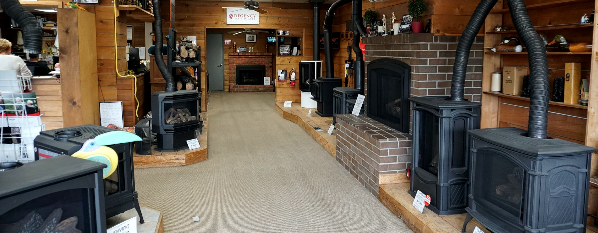 Indoor showroom featuring fireplace and stove displays in Olympia