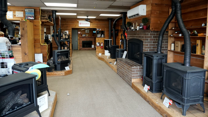 Indoor showroom featuring fireplace and stove displays in Olympia