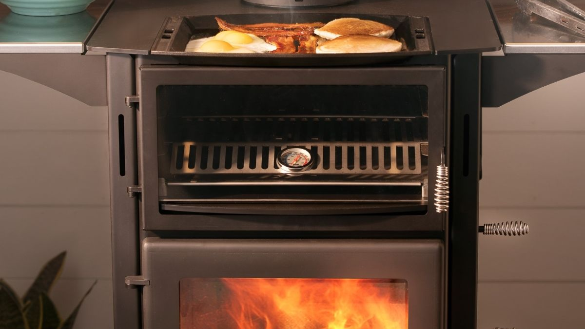 Kuma Applewood wood cookstove combining traditional wood heat and everyday cooking functionality in a rustic interior.