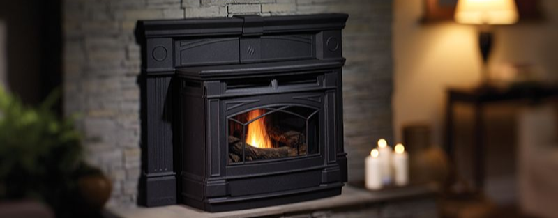 Pellet insert burning inside a traditional fireplace opening