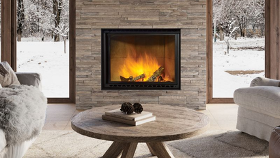 Wood fireplace with stone surround in a cozy living room