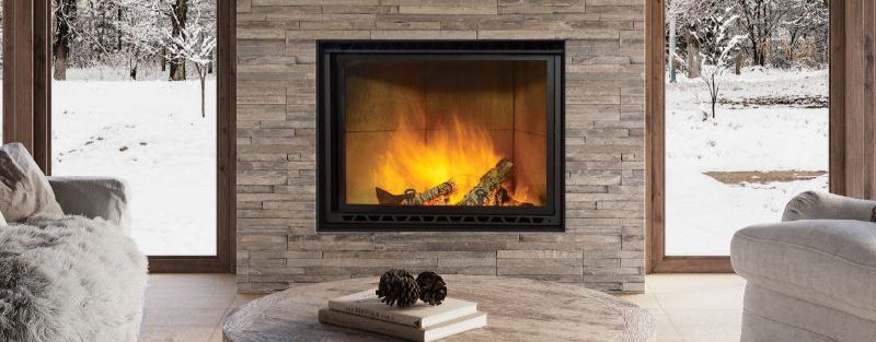 Wood fireplace with stone surround in a cozy living room