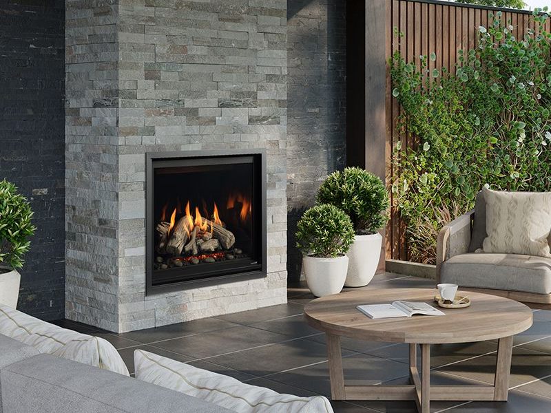 Outdoor fireplace with stone surround and patio seating designed for relaxing outdoor living