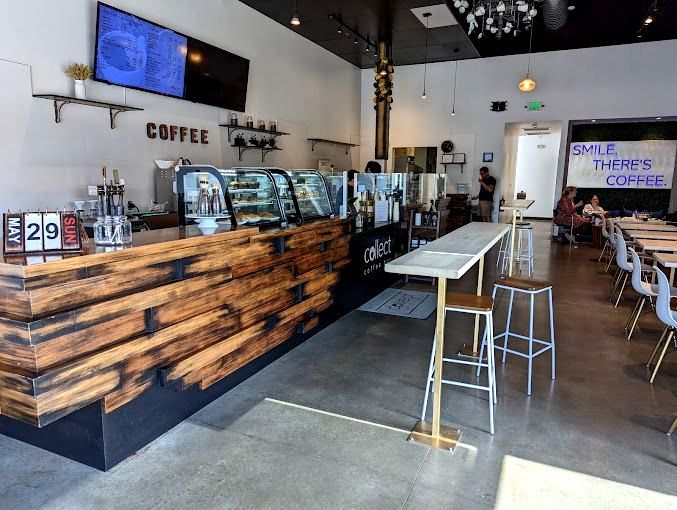 A coffee shop with a wooden counter and tables