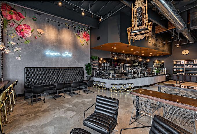 A restaurant with a lot of chairs and tables and a throne hanging from the ceiling.