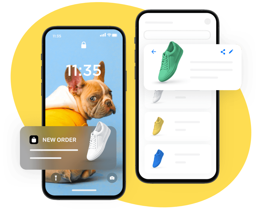 A dog is sitting on a phone next to a pair of shoes.