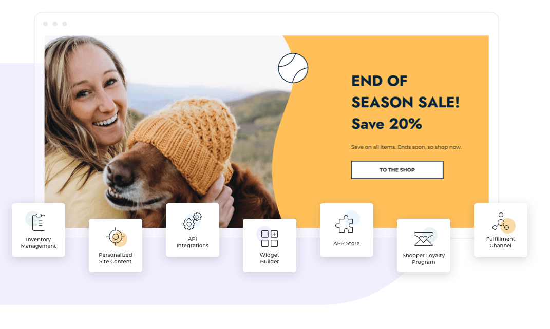 A woman is holding a dog wearing a hat.