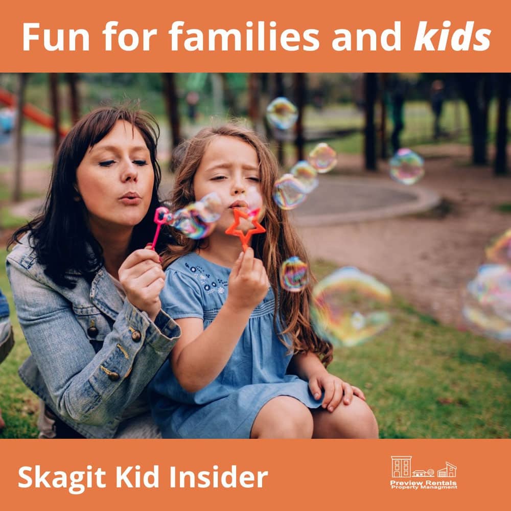 Photo of a mother and daughter blowing bubbles