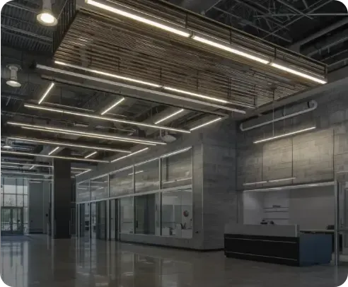 Modern industrial office with exposed ceiling lights, glass partitions, concrete walls, and polished floors