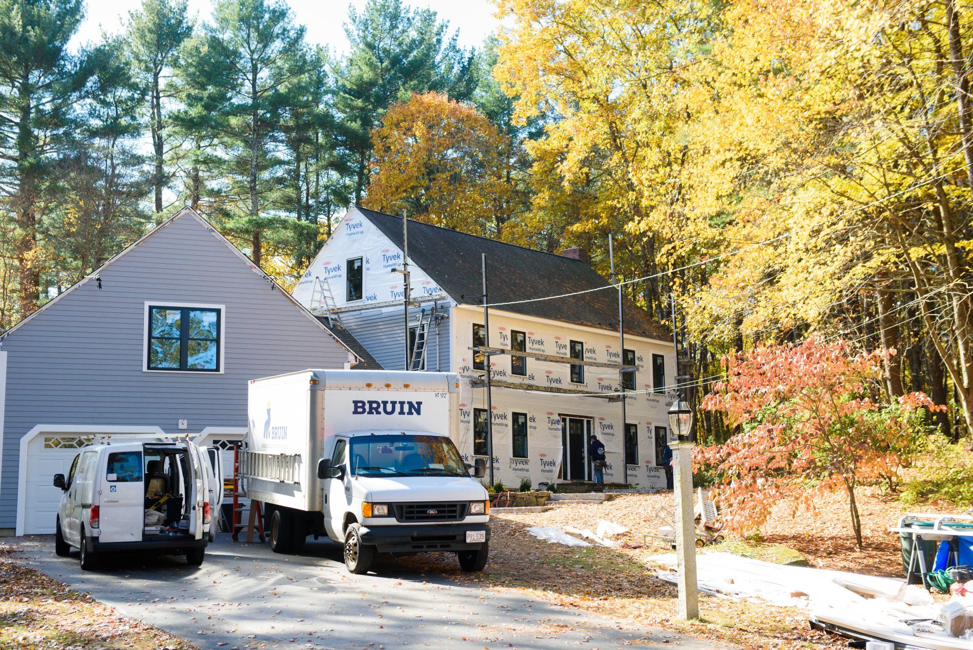 A white truck with the word muller on it is parked in front of a house