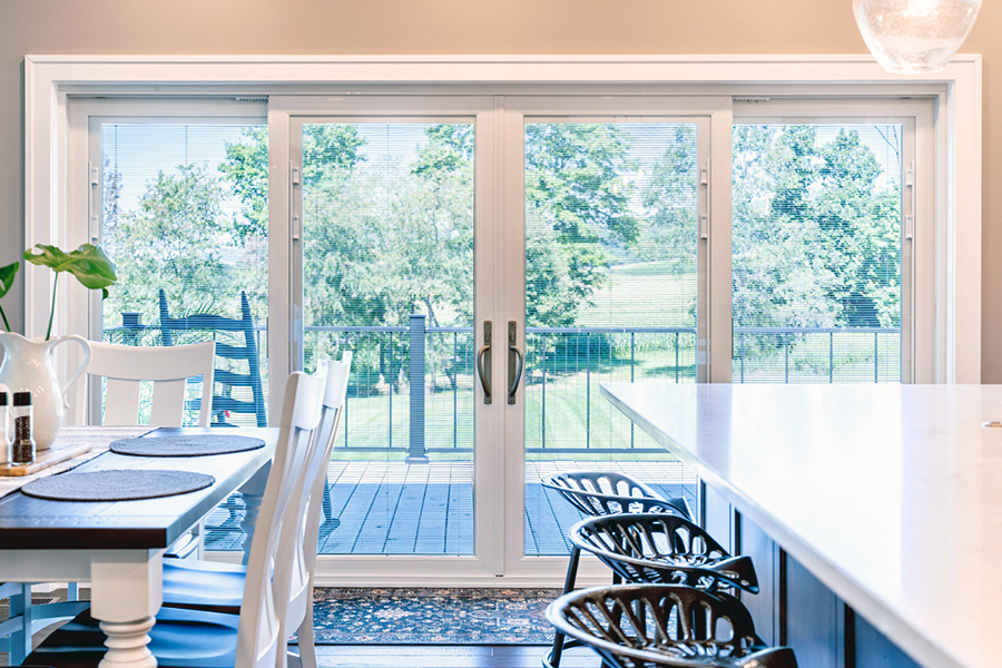 A kitchen with a lot of windows and a stove top oven.
