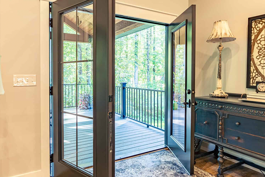 A door is open to a deck in a house.