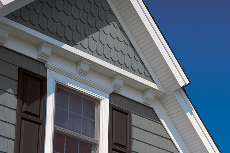 The roof of a house with a window and shutters