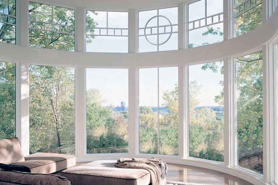 A living room with a couch and a lot of windows