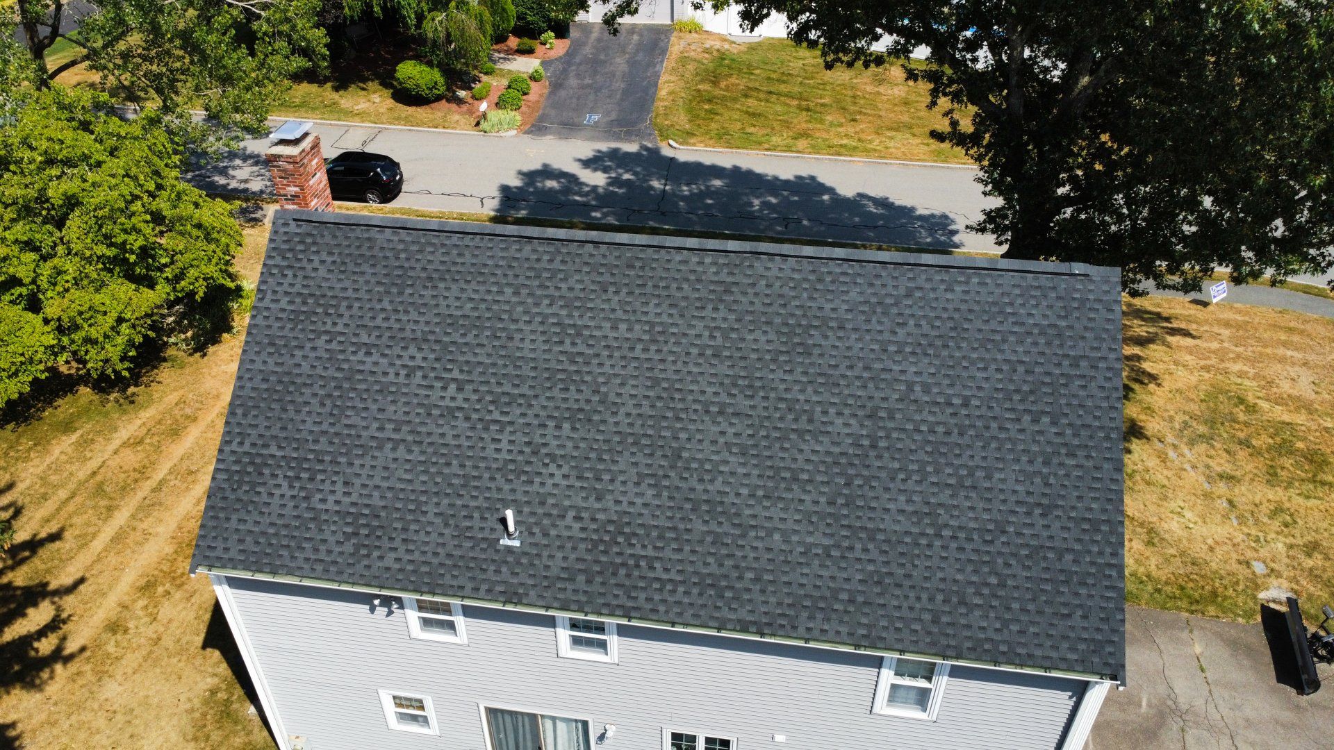 An aerial view of a house with a new roof.