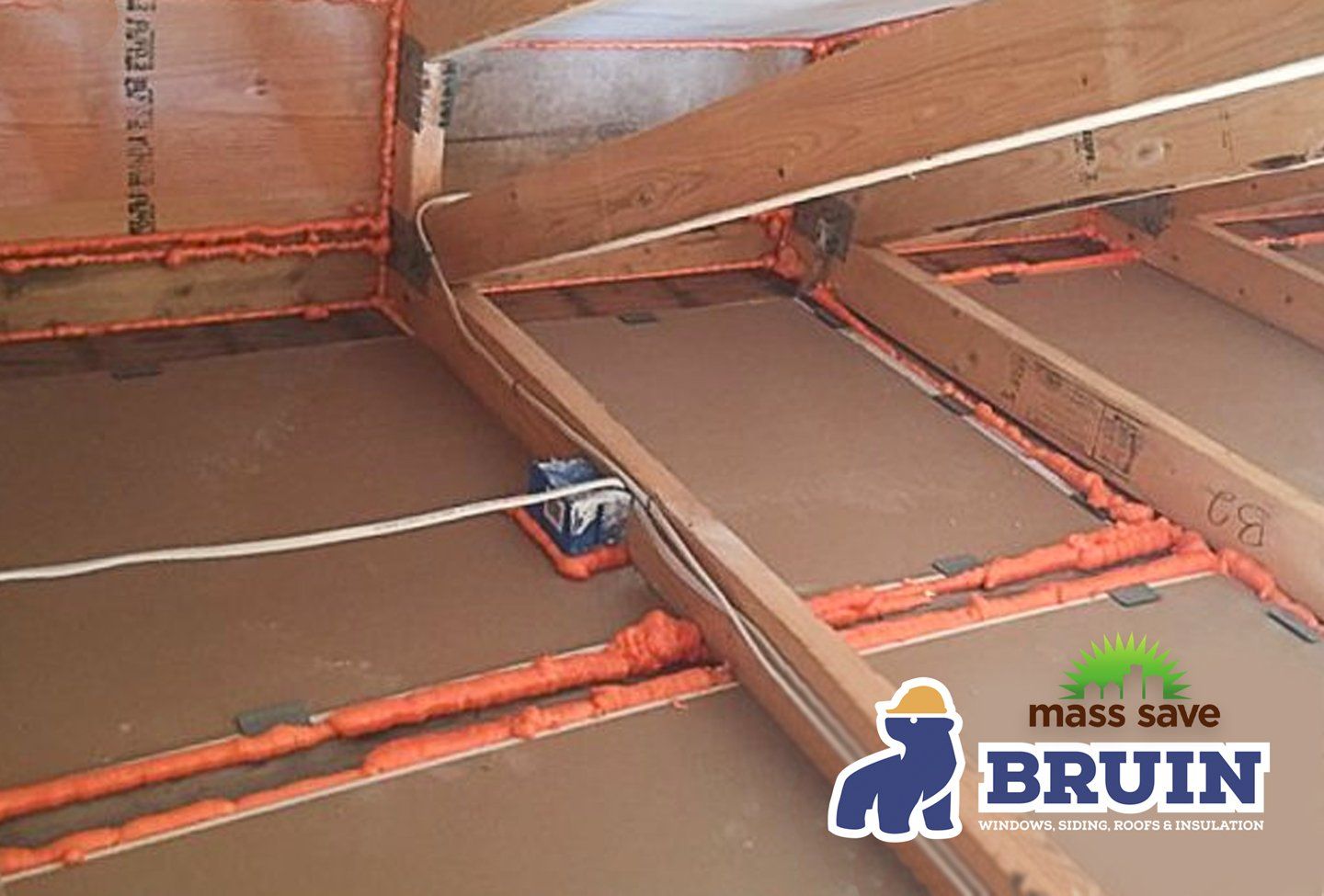 A mass save bruin logo is on a wooden floor
