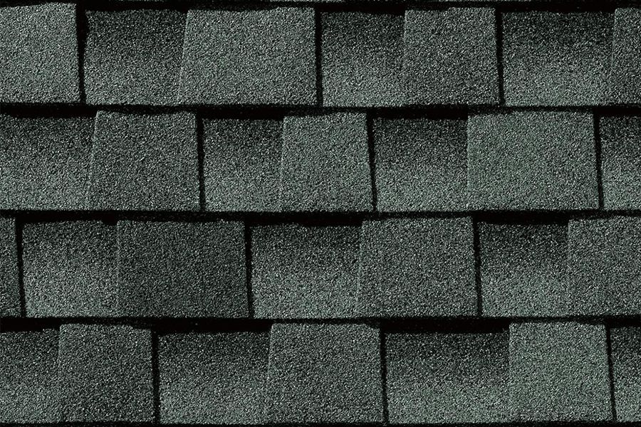 A close up of a roof with gray shingles