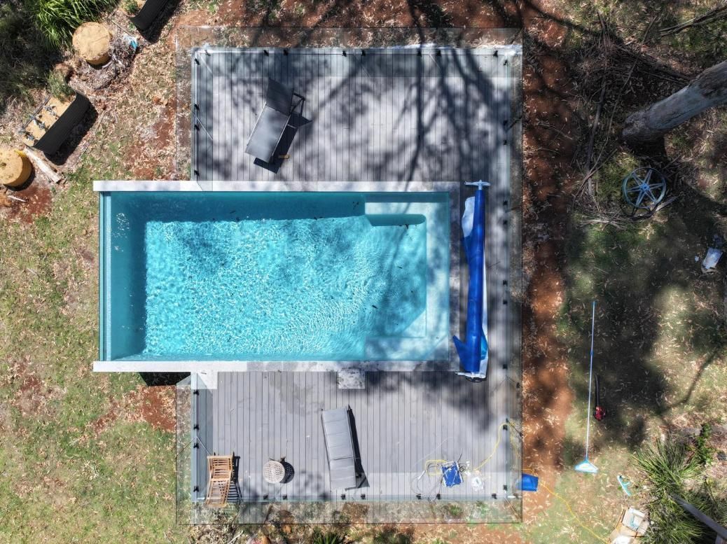 An Aerial View of a Swimming Pool in a Backyard Surrounded by Trees — Pools By Design in Beerwah, QLD