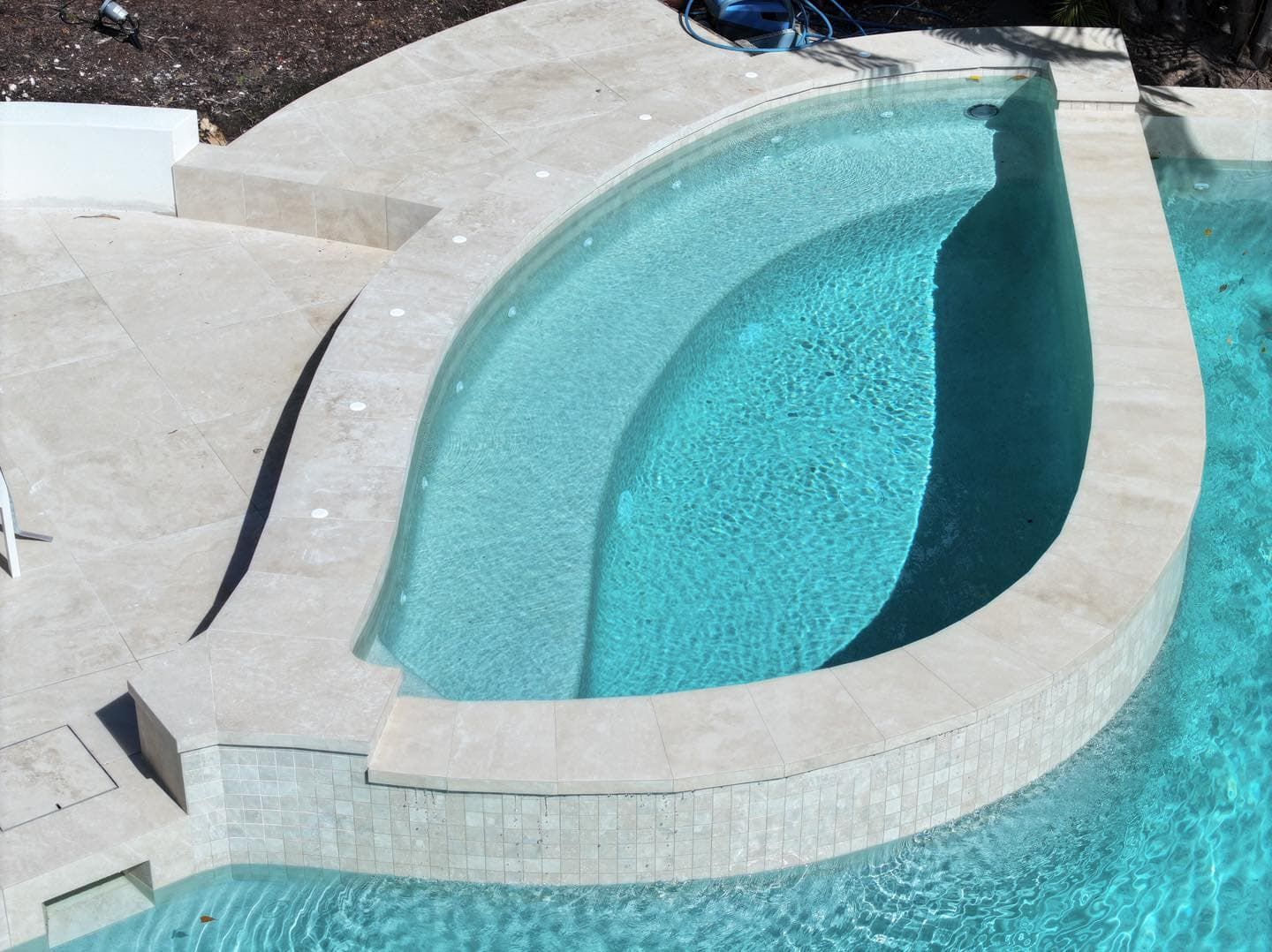 A Large Swimming Pool With a Curved Edge — Pools By Design in Warana, QLD