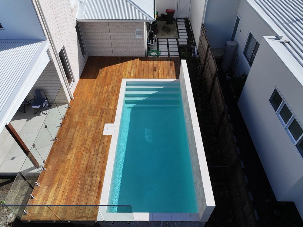 Aerial view of a modern backyard swimming pool designed by Pool Builders Sunshine Coast