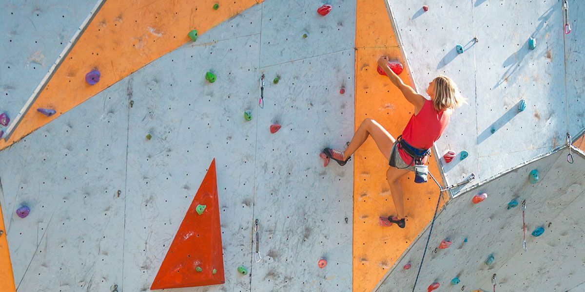Person rock climbing at outdoor gym
