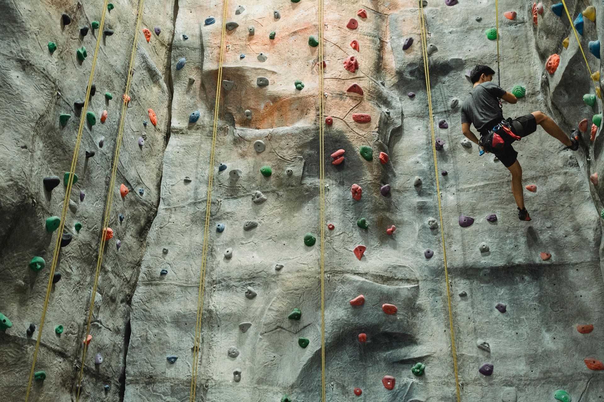 A man is climbing up a rock wall.