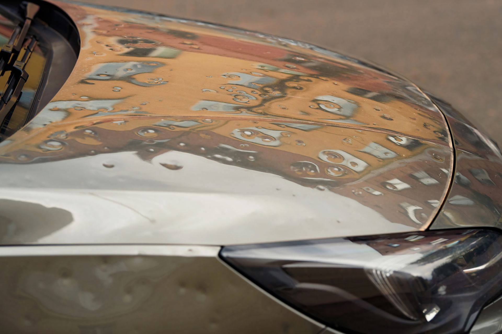 Damaged Car Hood With Peeling Paint, Reflecting Buildings — Airlie Beach Smash Repairs in Cannonvale, QLD