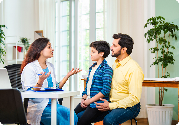 Doctor consulting with a child and parent in an office; the doctor gestures with her hands.