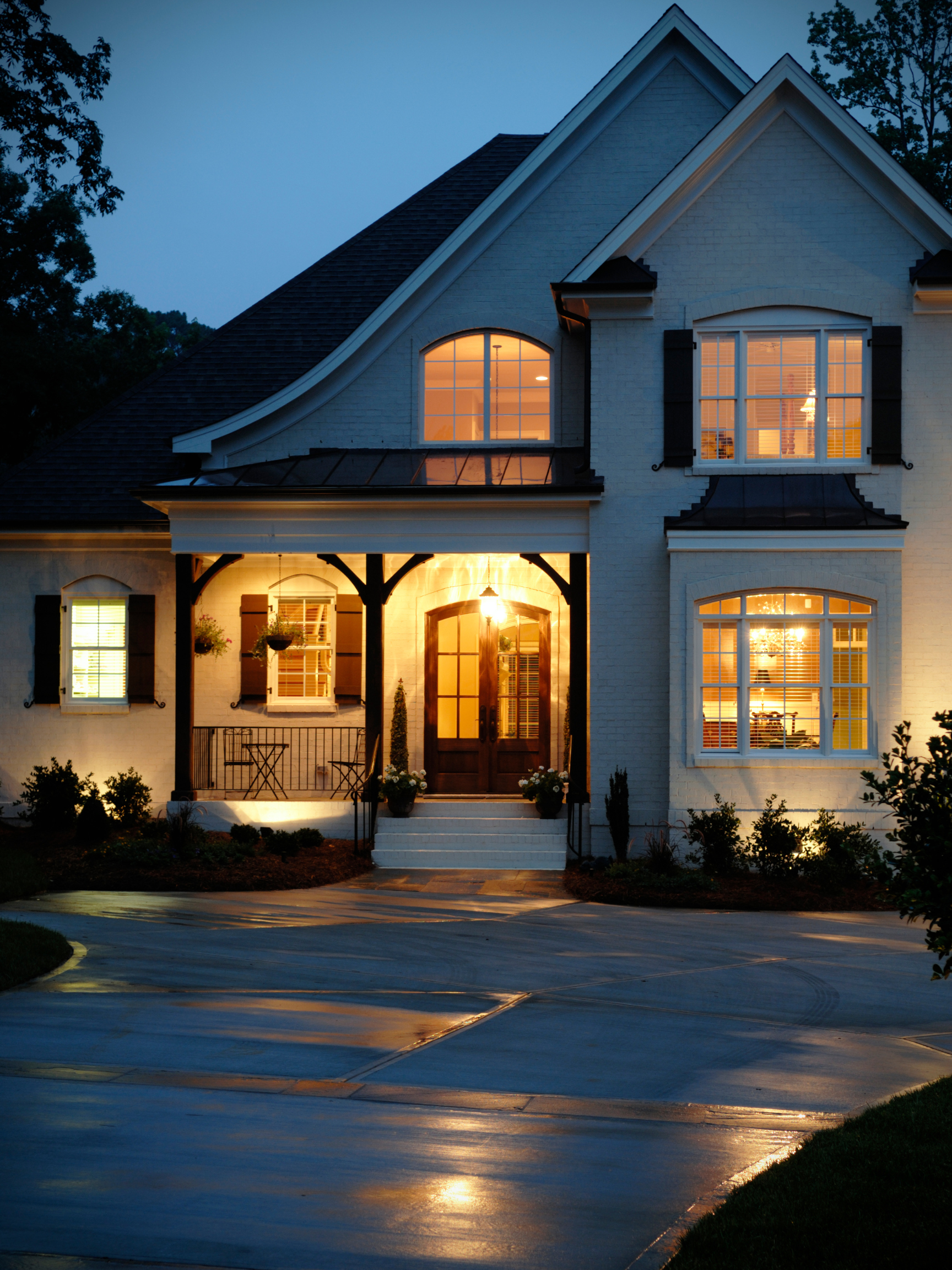 the front of a house is lit up at night