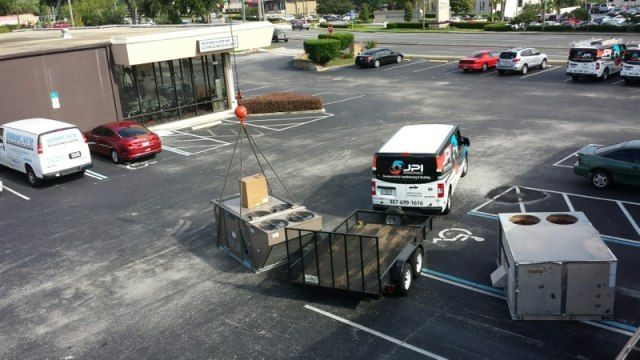 crane lifting HVAC unit