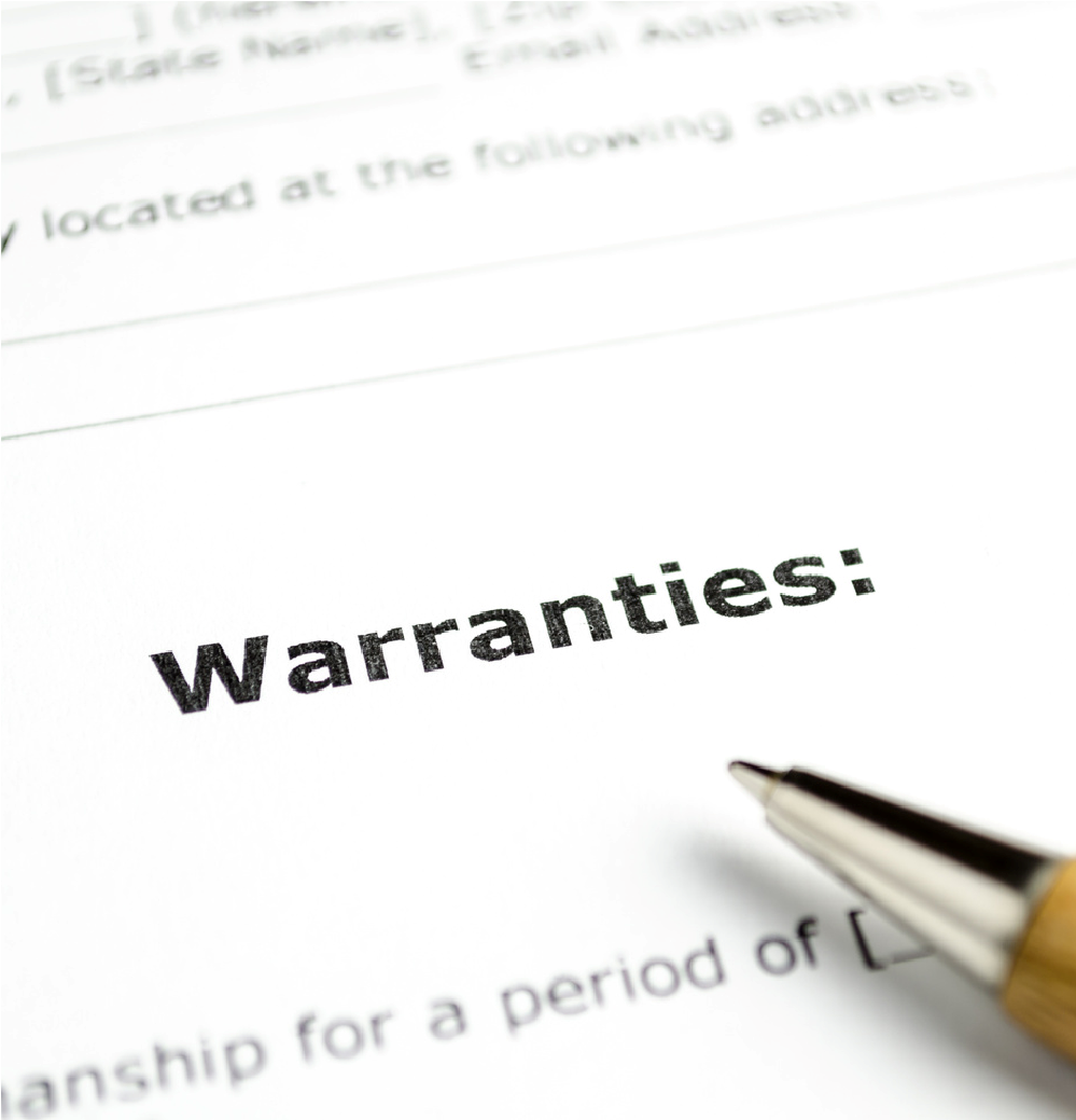 Close-up of a warranty document with a pen pointing at the word “Warranties.”