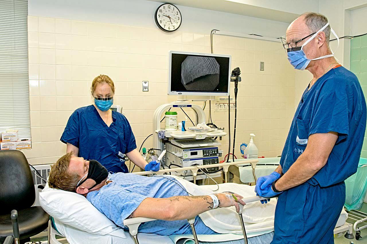 Surgeon consults with patient Surgeon consults with patient