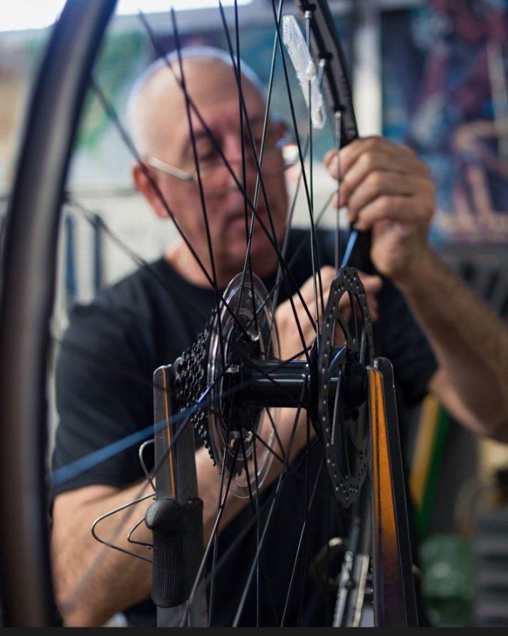Person fixing bicycle tire Person fixing bicycle tire