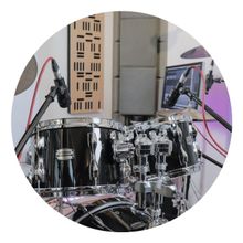 Circle with a drum set background, a 
