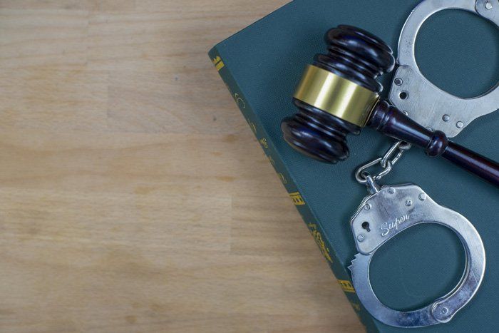 Gavel and Handcuffs on the Book — Somerset, PA — Yelovich Flower & McCoy
