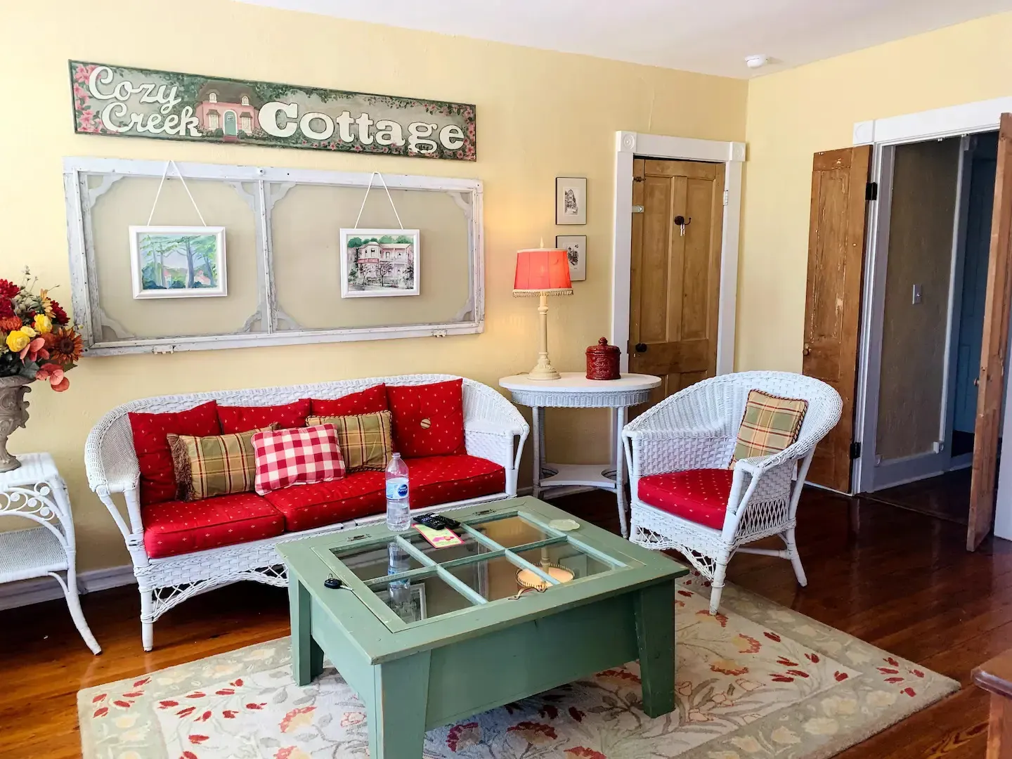 a living room with a couch , chairs , and a green coffee table .