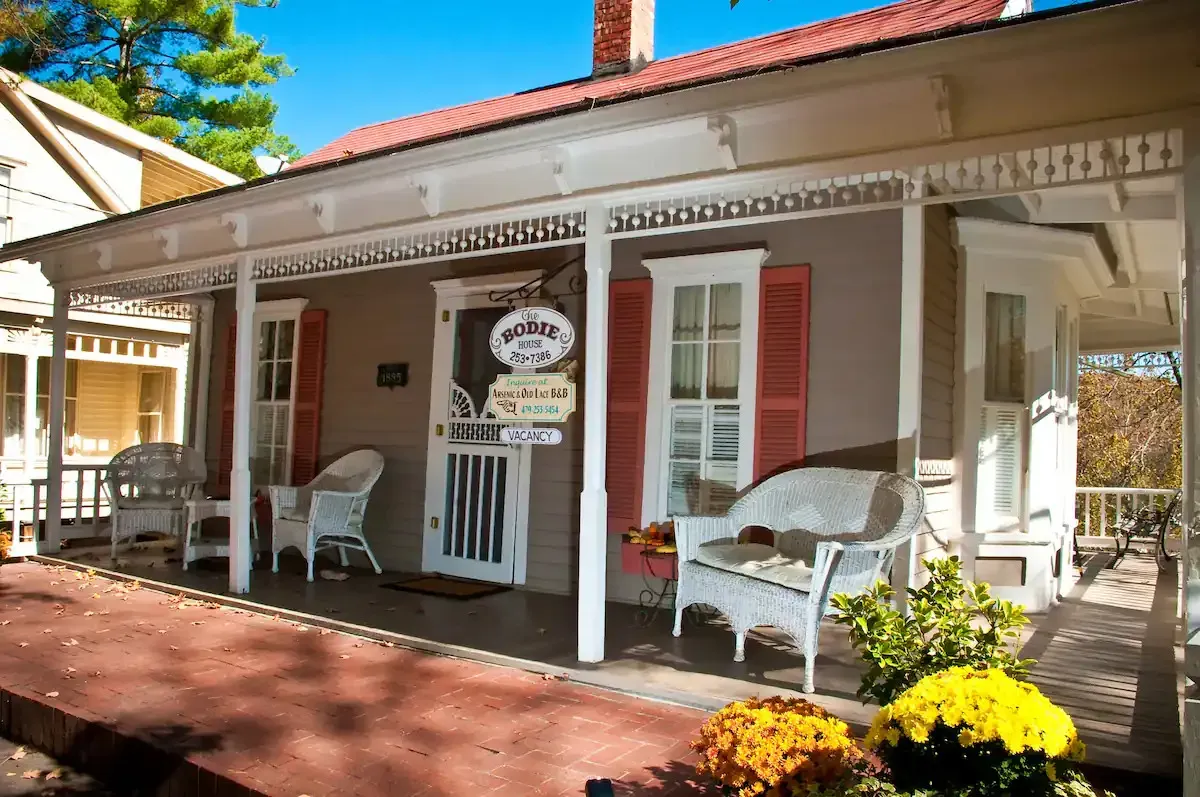 a house with a porch and chairs on it