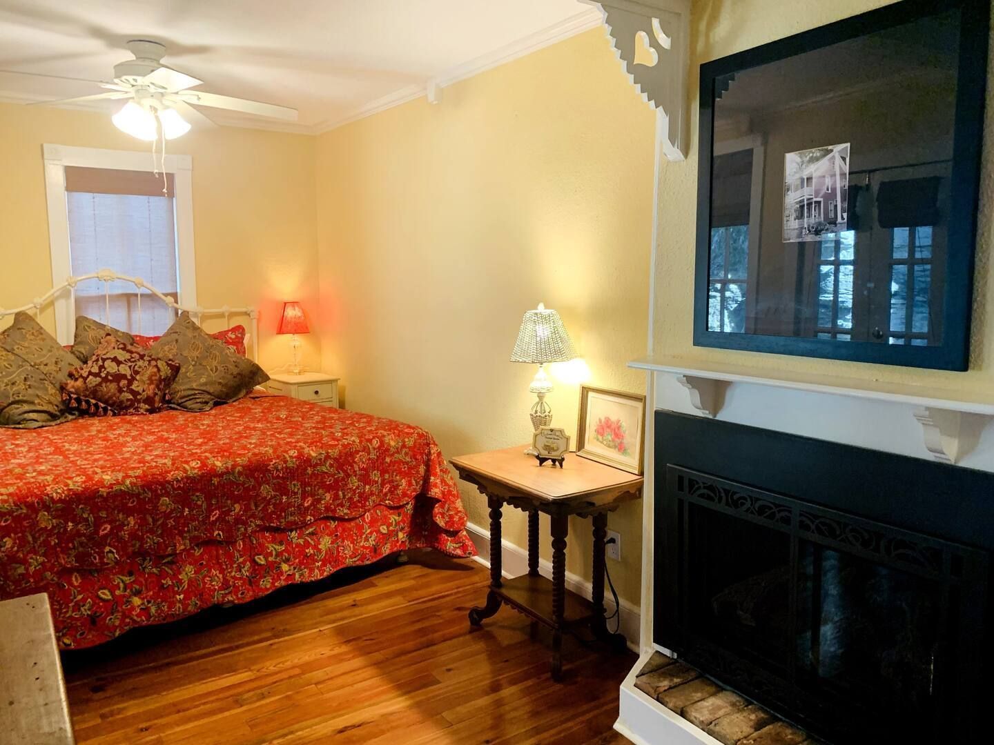a bedroom with a fireplace and a large bed